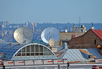 satellite dish heap on the building roof, urban diversity