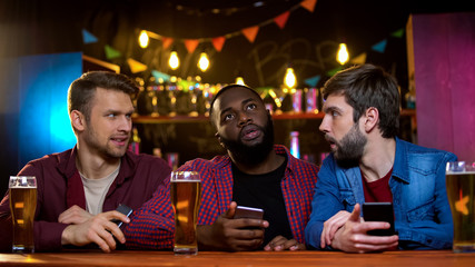 Male friends blaming their african-american friend for loss of team, bet failure