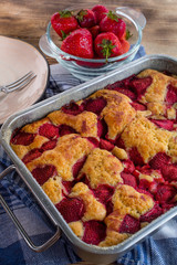 Yeast cake with strawberry in a mold.