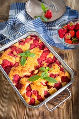 Yeast cake with strawberry in a mold.