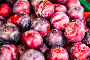 Fresh Plums layed out at the Grocery