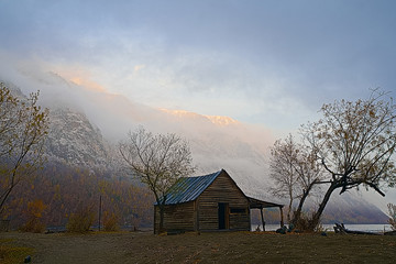 Fototapeta premium old house near the mountain in winter