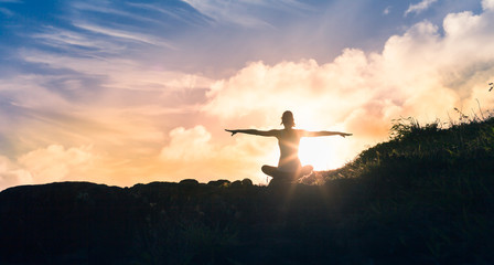 Young female feeling enlightened, energized and at peace in nature. 