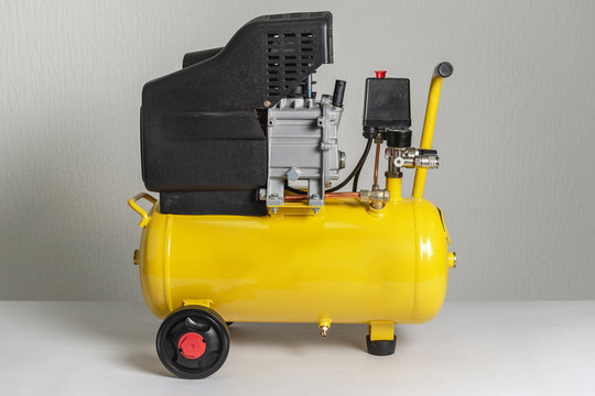 Yellow Piston Air Compressor. Compressing and Supplying Air Machine.