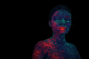 Portrait of a beautiful girl alien. Ultraviolet body art aquamarine night sky with stars and pink jellyfish.
