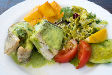 fried cod with vegetables and sauce