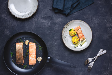 Grilled Salmon Steak with Yellow Risotto and Lime on Stone Background