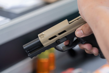 A man holding a gun in hand, the ship ready to shoot for self defense, Criminal concept