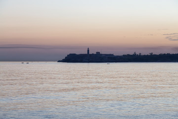 Fototapeta premium Beautiful view of the Old Havana City, Capital of Cuba, during a colorful cloudy sunrise.