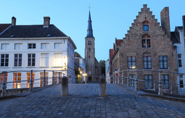 Scenic city view of Bruges with beautiful medieval houses and Saint Anne church in the background...