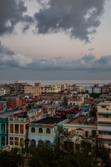 Aerial view of the residential homes in Havana City, Capital of Cuba, during a colorful cloudy sunrise.