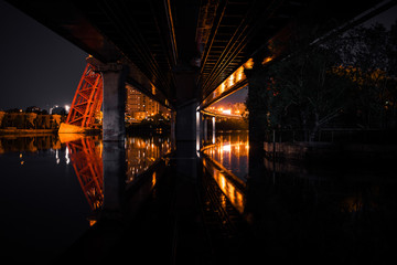 reflection of the bridge at night in the city