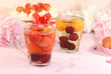 Summer strawberry juice and fresh strawberries on a pink background. Summer drinks and delicious strawberry cake, selective focus