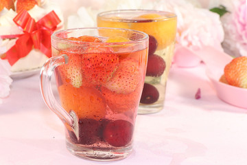 Summer strawberry juice and fresh strawberries on a pink background. Summer drinks and delicious strawberry cake, selective focus