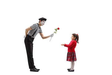 Pantomime man giving a red rose to a little girl