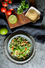 Lebanese Tabbouleh salad with bulgur, parsley, mint, tomatoes and seasoning