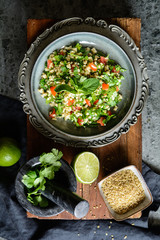 Lebanese Tabbouleh salad with bulgur, parsley, mint, tomatoes and seasoning