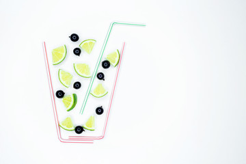 Assortment of fruit and vegetables smoothies in glass bottles with straws on white wooden background. Fresh organic Smoothie ingredients. Superfoods and health or detox diet food concept.