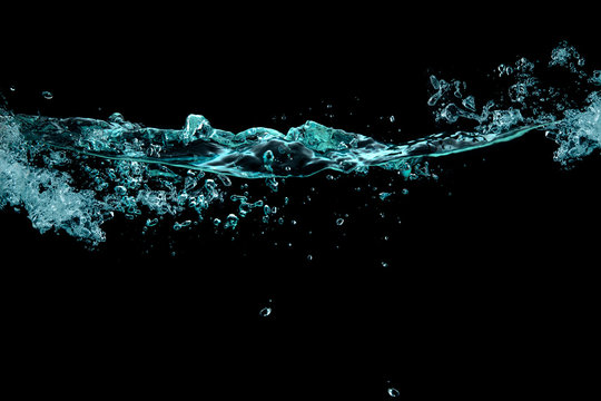 Turbulence, splash and bubbles on a liquid surface. waterline over black background