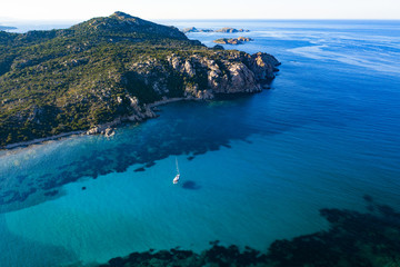 View from above, stunning aerial view of a sailing boat floating on a beautiful turquoise clear...