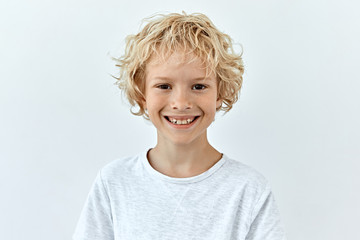 Little child boy portrait against white background. Laughter and joy emotions - obrazy, fototapety, plakaty