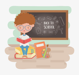 little student boy with chalkboard and school supplies