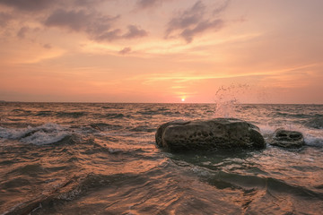 Fototapeta na wymiar Seawaves hitting rocks on beach.