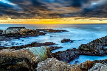 Sunset over Beach, Ocean, Sea with Threatening Clouds