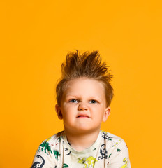 little boy in white shirt isolated onyellow background