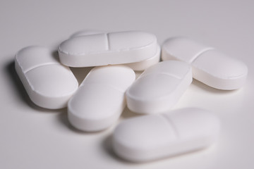 Close up / macro of white medical pills on table