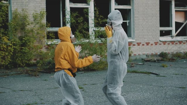 Scientists put on respirators and dance for a rap clip. Girls in a protective suit from radiation moving to the music. Environmental theme. Terrible abandoned territory in Novosibirsk.