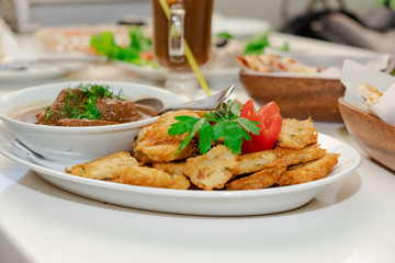 National Jewish dish - Fleish mit latex - beef stew with potato pancakes