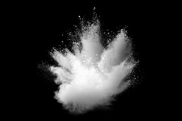 Freeze motion of white color powder exploding on dark background.  - obrazy, fototapety, plakaty