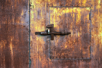 Vintage steel door with chipped paint and rusted lock.