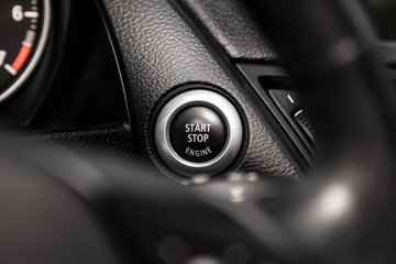 Car engine push start stop button ignition remote starter. Car dashboard:  black engine start stop...
