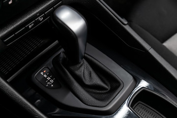 Close up of the automatic gearbox lever, blackinterior car; Automatic transmission gearshift stick; - obrazy, fototapety, plakaty