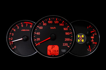 Car dashboard wuth red backlight: Odometer, speedometer, tachometer, fuel level, water temperature and more