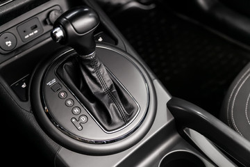Fototapeta na wymiar Close up of the automatic gearbox lever, blackinterior car; Automatic transmission gearshift stick;