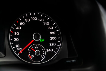 Car dashboard wuth white backlight: Odometer, speedometer, tachometer, fuel level, water temperature and more