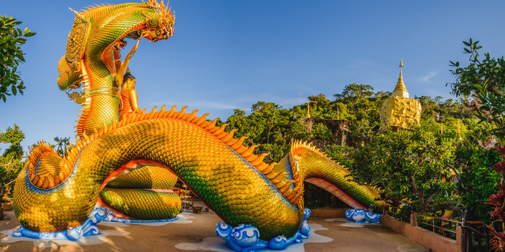 Big gold buddha and naga status in tham pha daen temple, the famous place of Sakon Nakhon Province, Thailand