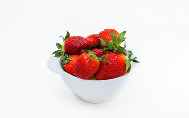 white bowl full of large red strawberries on white background