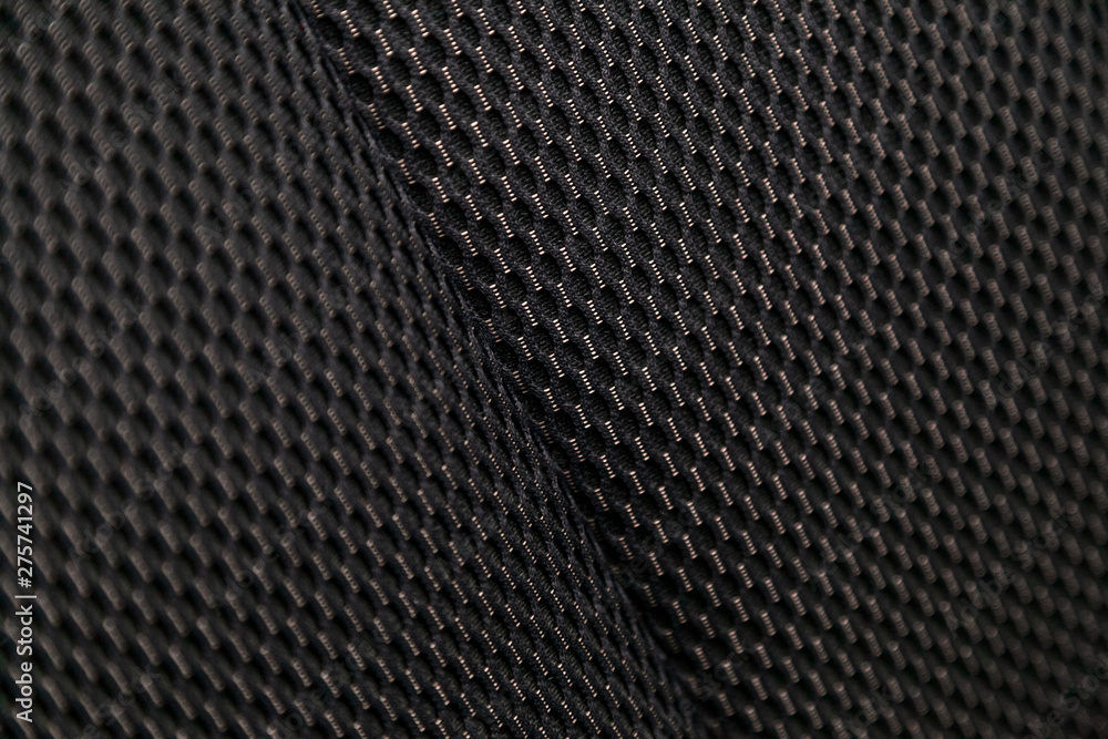 Wall mural Close-up black car seat trim. Soft rough carbon fabric texture.