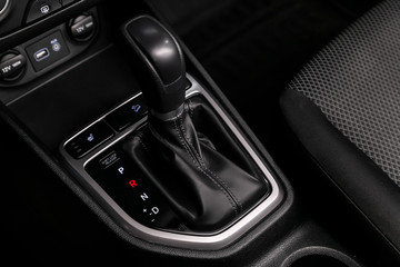 Fototapeta na wymiar Close up of the automatic gearbox lever, blackinterior car; Automatic transmission gearshift stick;