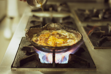 Japanese food meat  steaming in clay pot on fire stove