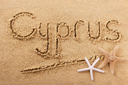 Cyprus word written in sand on a sunny summer beach with starfish holiday vacation travel destination sign writing message photo