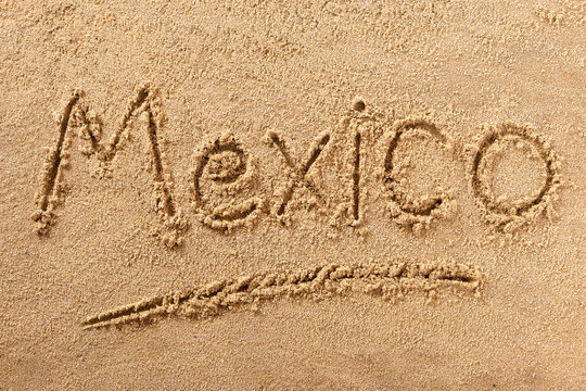 Mexico word written in sand on a sunny mexican cancun summer beach holiday vacation travel destination sign writing message photo