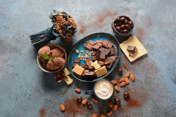 Cup of coffee, black and white chocolate, almond nuts. Coffee break concept