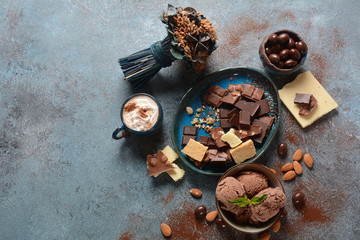 Cup of coffee, black and white chocolate, almond nuts. Coffee break concept
