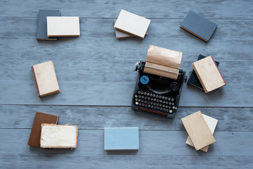 Old typewriter on a writer wooden desk flat lay background with copy space.