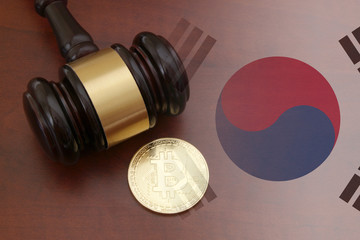 Judge gavel and bitcoin on wooden table with korean flag